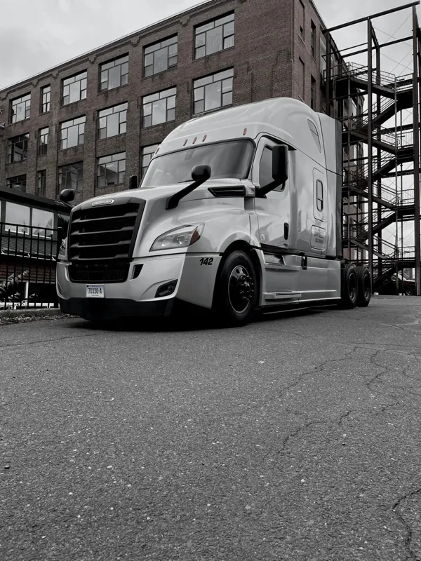 Silver truck in front of a brick building